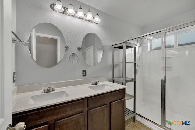 2588 Diamondback Trl, New Braunfels, TX 78130 - full bathroom featuring a stall shower, double vanity, and tile patterned floors