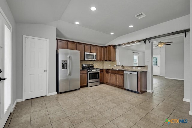2588 Diamondback Trl, New Braunfels, TX 78130 - kitchen featuring appliances with stainless steel finishes, lofted ceiling, light tile patterned flooring, decorative backsplash, and a ceiling fan