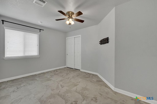 2588 Diamondback Trl, New Braunfels, TX 78130 - unfurnished bedroom with a closet, ceiling fan, and marble finish floors