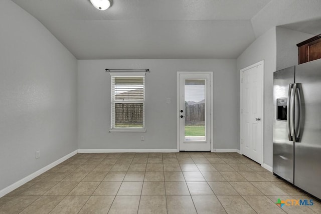 2588 Diamondback Trl, New Braunfels, TX 78130 - unfurnished dining area featuring vaulted ceiling and light tile patterned floors