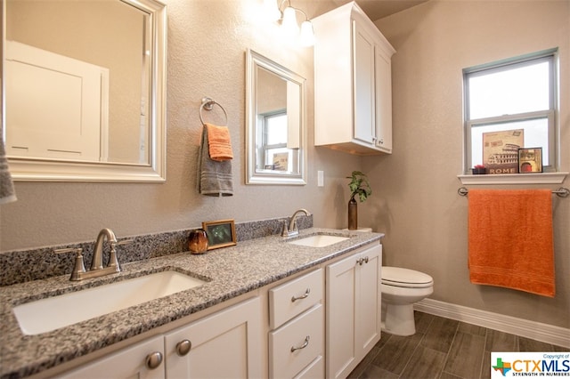 bathroom with vanity, hardwood / wood-style flooring, and toilet