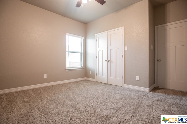 unfurnished bedroom featuring carpet, ceiling fan, and a closet