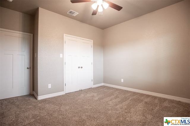 unfurnished bedroom featuring carpet and ceiling fan