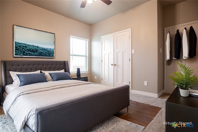 bedroom with a closet, hardwood / wood-style flooring, and ceiling fan