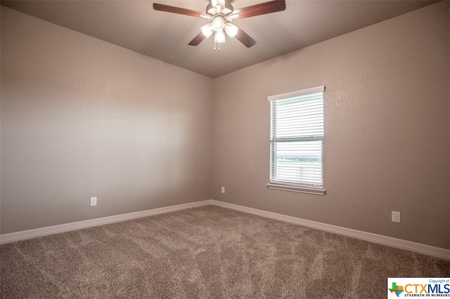 carpeted spare room featuring ceiling fan