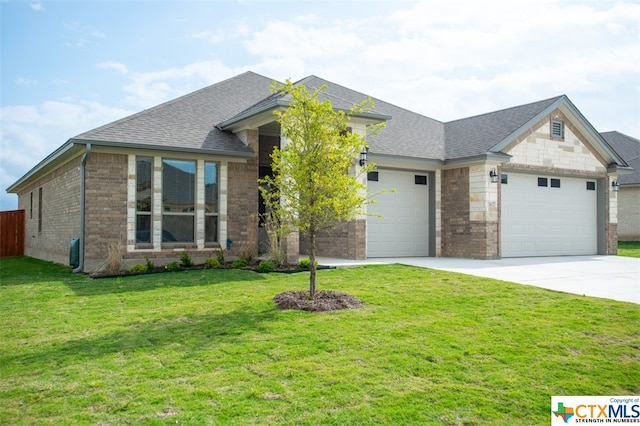 view of front of home with a front lawn and a garage