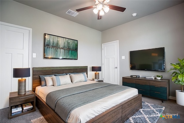 bedroom featuring ceiling fan and dark carpet