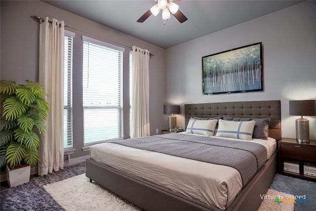 bedroom featuring multiple windows, carpet flooring, and ceiling fan