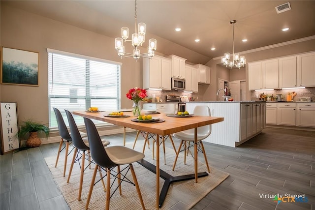 1027 Winchester Dr, Nolanville, TX 76559 - dining space with a chandelier, dark wood-type flooring, recessed lighting, and ornamental molding