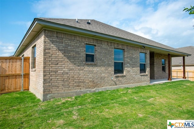 1027 Winchester Dr, Nolanville, TX 76559 - back of property featuring brick siding and a patio area
