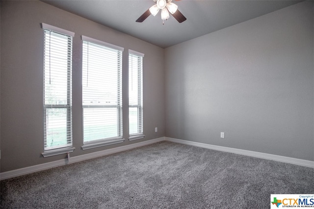 carpeted spare room with ceiling fan