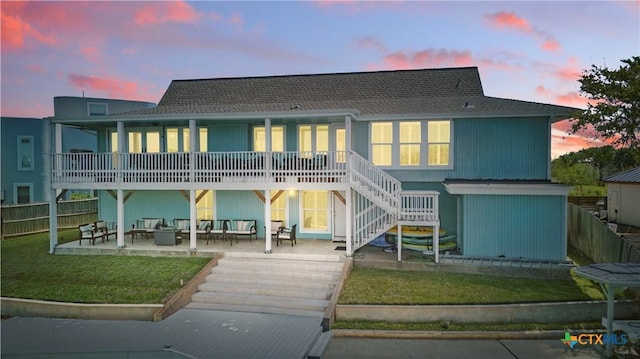 25 Blue Heron Cir, Rockport, TX 78382 - back of property featuring fence, stairs, an outdoor living space, a patio, and a yard