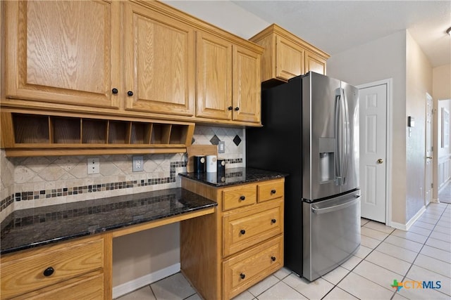 2109 Grizzly Trl, Harker Heights, TX 76548 - kitchen featuring stainless steel refrigerator with ice dispenser, light tile patterned floors, dark stone countertops, and tasteful backsplash