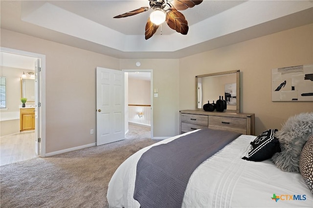 2109 Grizzly Trl, Harker Heights, TX 76548 - carpeted bedroom with a tray ceiling, baseboards, connected bathroom, and ceiling fan