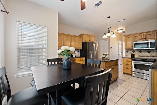 2109 Grizzly Trl, Harker Heights, TX 76548 - kitchen featuring stainless steel appliances, dark countertops, tasteful backsplash, a ceiling fan, and light tile patterned flooring