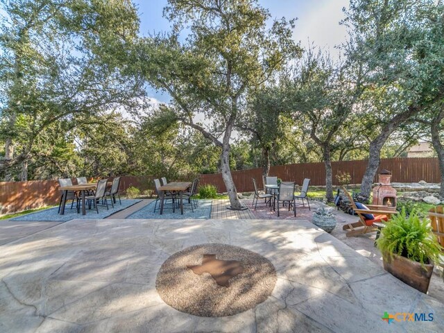 view of patio / terrace featuring an outdoor stone fireplace