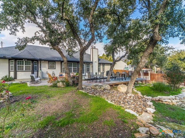 back of house with a patio