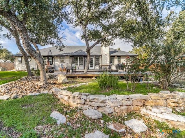 back of house with a lawn and a wooden deck