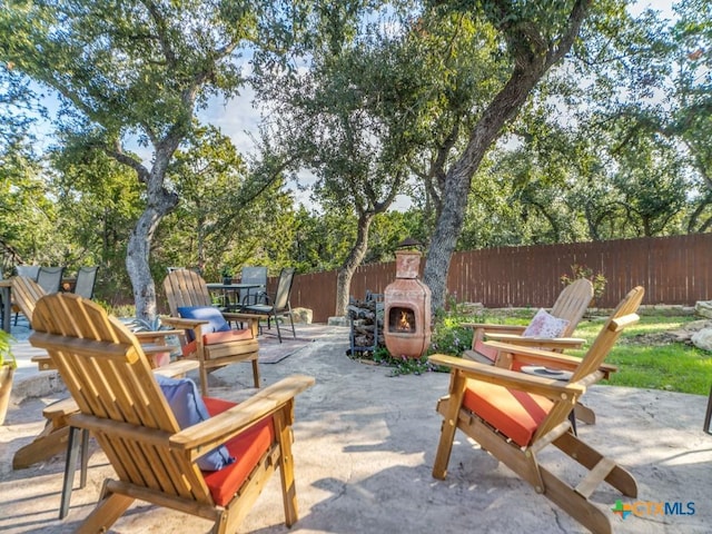 view of patio with exterior fireplace