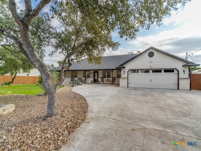 ranch-style home with a porch and a garage