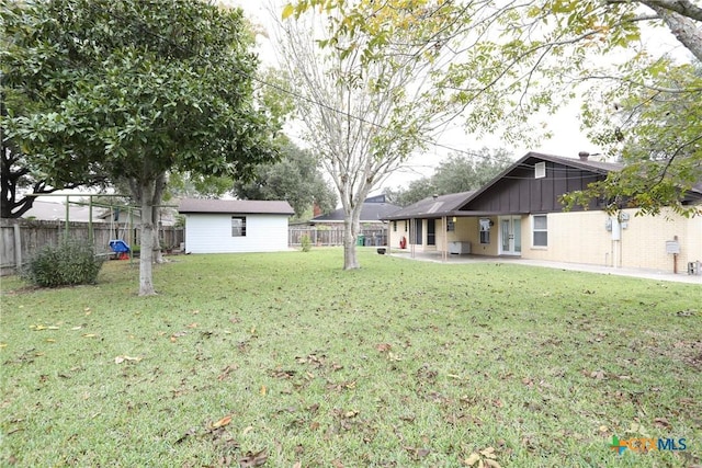 view of yard featuring an outbuilding and a patio area