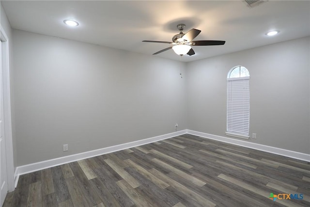 empty room with dark hardwood / wood-style floors and ceiling fan