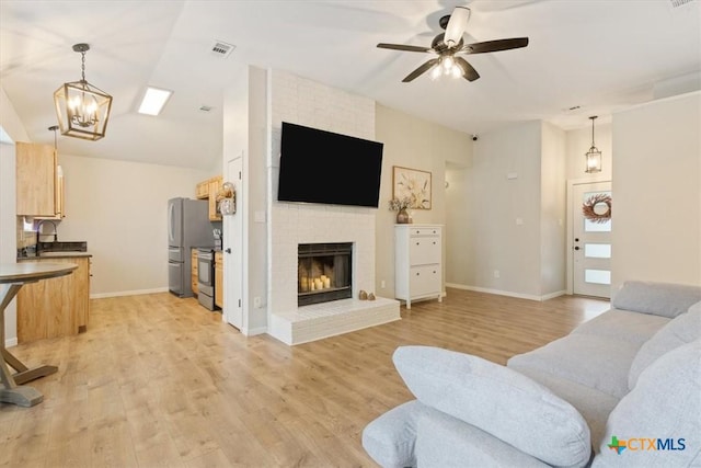 8620 Sunset Trl, Temple, TX 76502 - living area featuring light wood-style flooring, a fireplace, ceiling fan, and vaulted ceiling