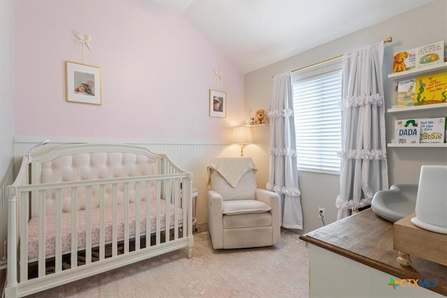 8620 Sunset Trl, Temple, TX 76502 - bedroom with a crib, vaulted ceiling, carpet, and a wainscoted wall
