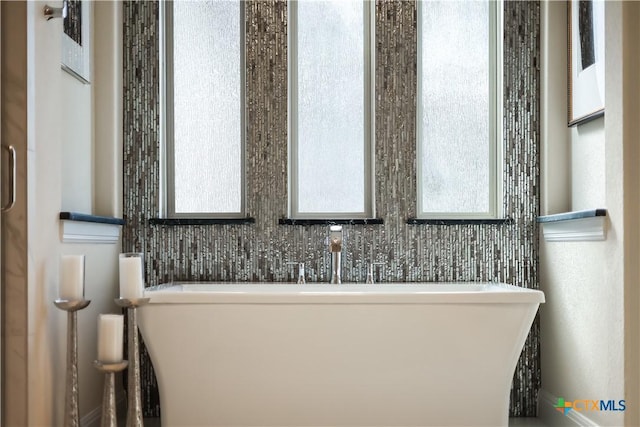 bathroom with a bathing tub and plenty of natural light