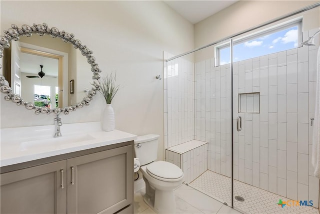 bathroom featuring toilet, a healthy amount of sunlight, tile patterned floors, and vanity