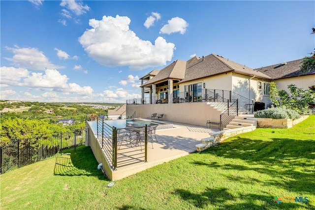 back of property featuring a lawn and a patio