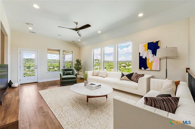 living room featuring ceiling fan, a wealth of natural light, and hardwood / wood-style flooring