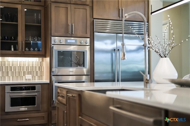 kitchen featuring backsplash and stainless steel appliances