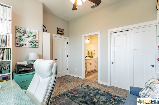 carpeted home office with ceiling fan