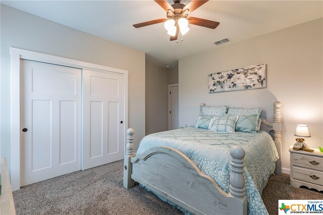 carpeted bedroom featuring ceiling fan and a closet