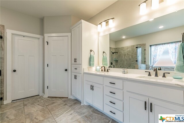 bathroom with walk in shower and vanity