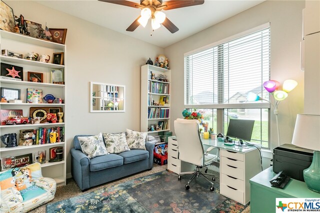 carpeted home office with ceiling fan