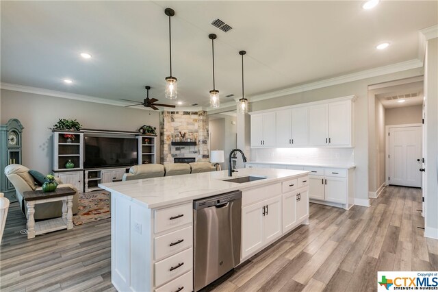 kitchen featuring dishwasher, white cabinetry, sink, and a center island with sink