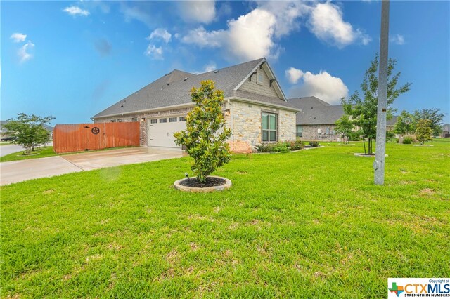 view of home's exterior featuring a garage and a yard