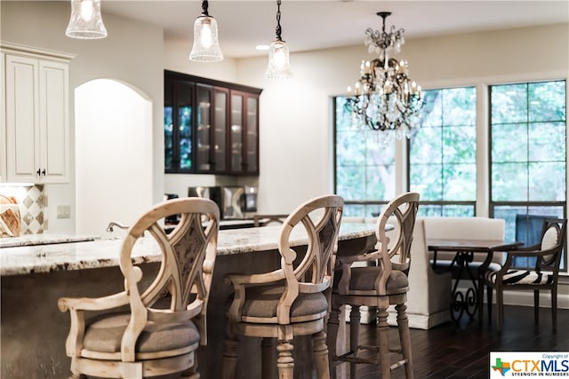 interior space featuring a notable chandelier and dark hardwood / wood-style floors