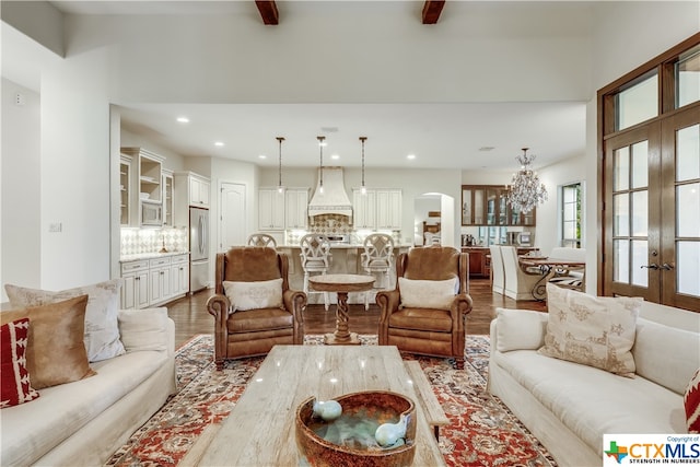 living room with an inviting chandelier, wood-type flooring, and french doors