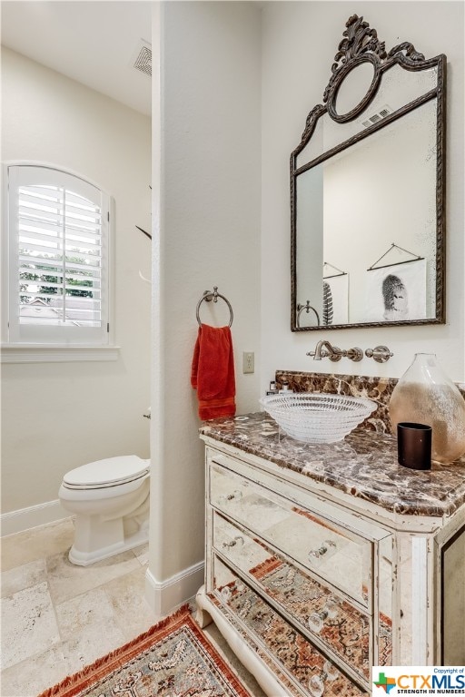 bathroom with toilet and vanity