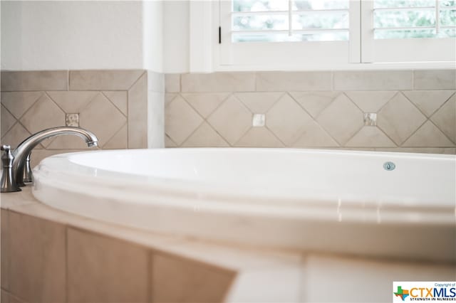 bathroom featuring a washtub