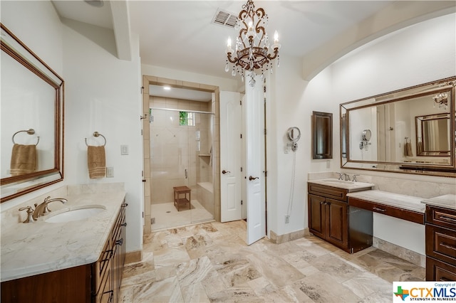 bathroom featuring walk in shower, vanity, and a notable chandelier