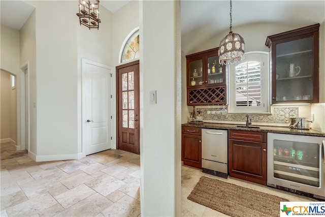 bar featuring pendant lighting, a healthy amount of sunlight, beverage cooler, and an inviting chandelier