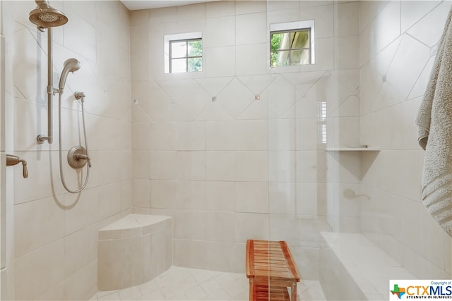 bathroom with a tile shower