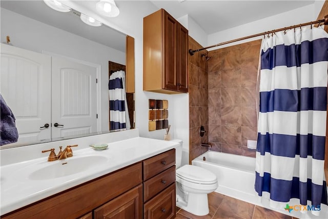 full bathroom featuring tile patterned floors, shower / tub combo with curtain, vanity, and toilet