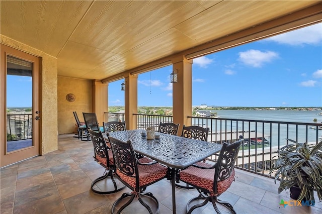 view of patio / terrace featuring a water view and a balcony