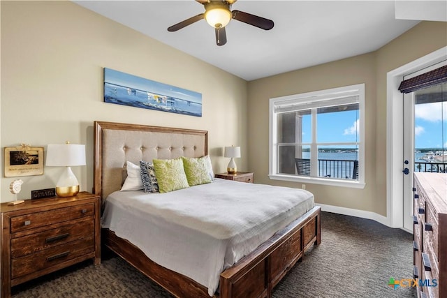 bedroom with access to outside, multiple windows, ceiling fan, and dark colored carpet