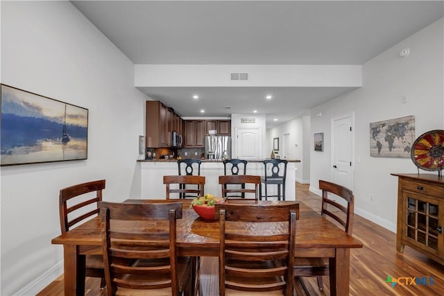 dining space featuring light hardwood / wood-style floors